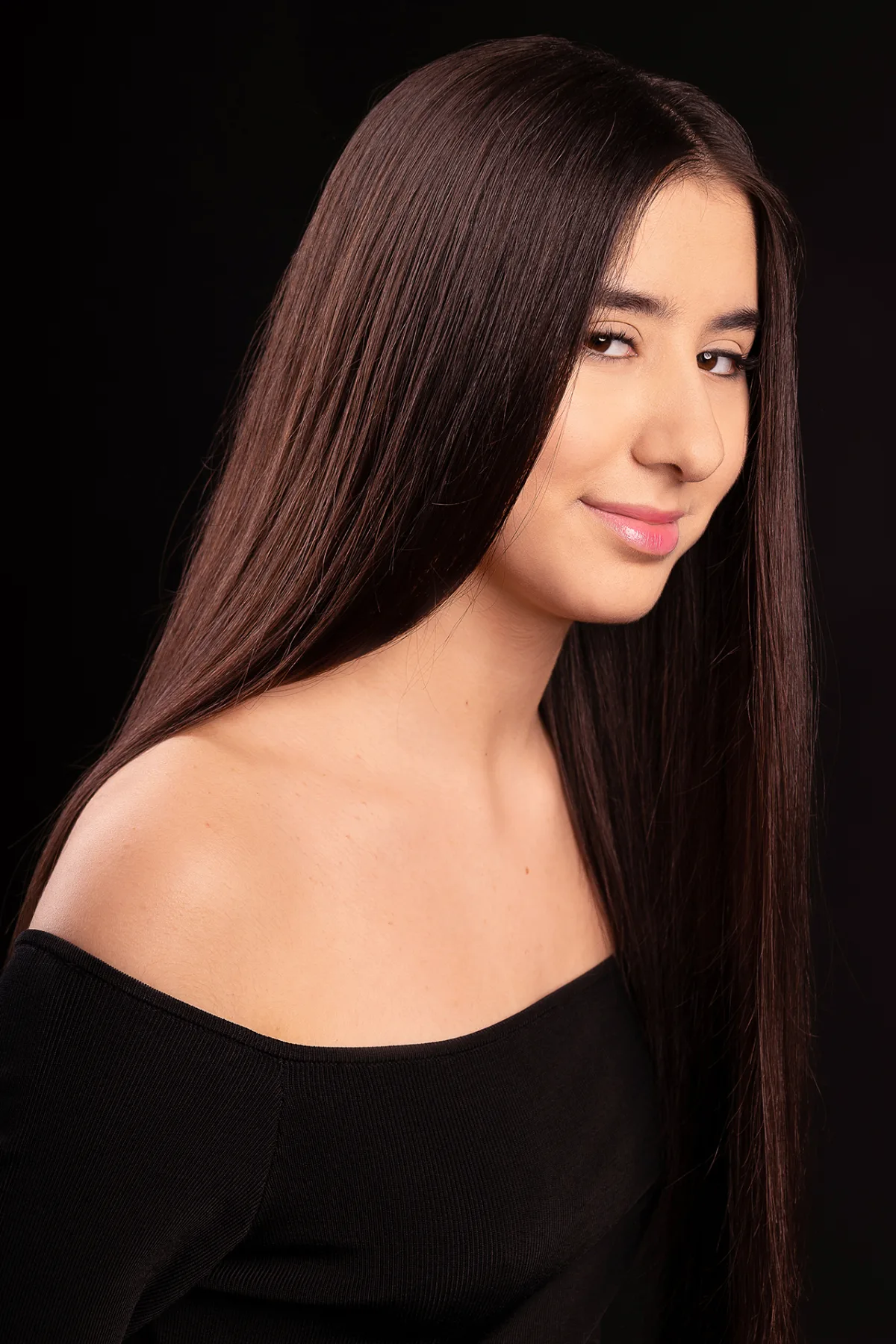 Beauty portrait of a young woman, gently smiling, long brown hair