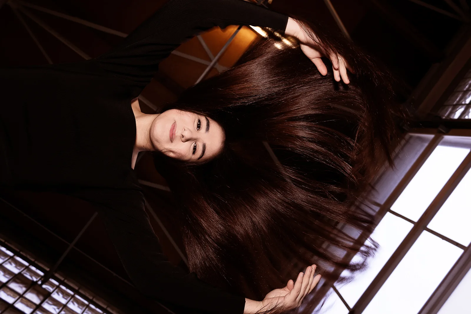 Another beauty portrait of the same young woman, black studio backdrop